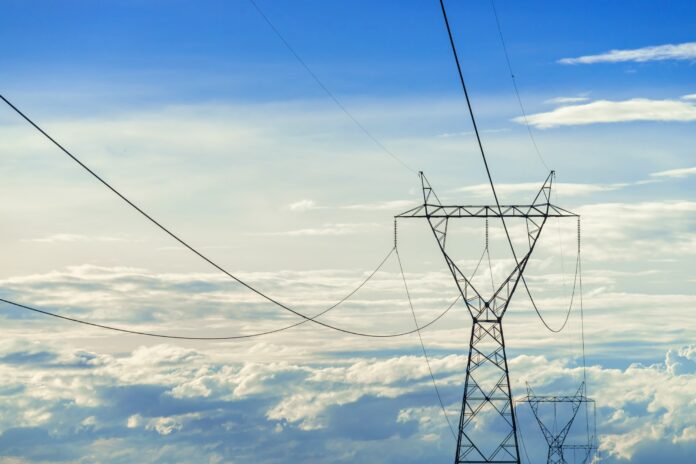 high voltage electric pole,High voltage power pole on blue sky background