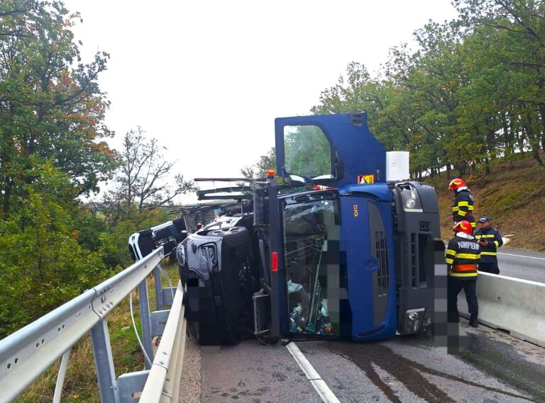 Un TIR încărcat cu mașini s-a răsturnat! Șoferul s-a autoevacuat. Unul dintre autoturismele transportate a ajuns într-o râpă